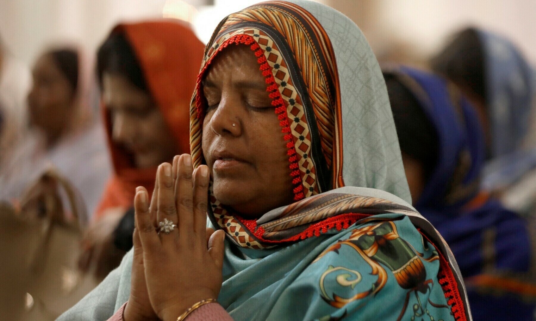 A woman, along with others, attends a Christmas Day service at the St. John’s Cathedral in Peshawar, on December 25, 2022. — Reuters