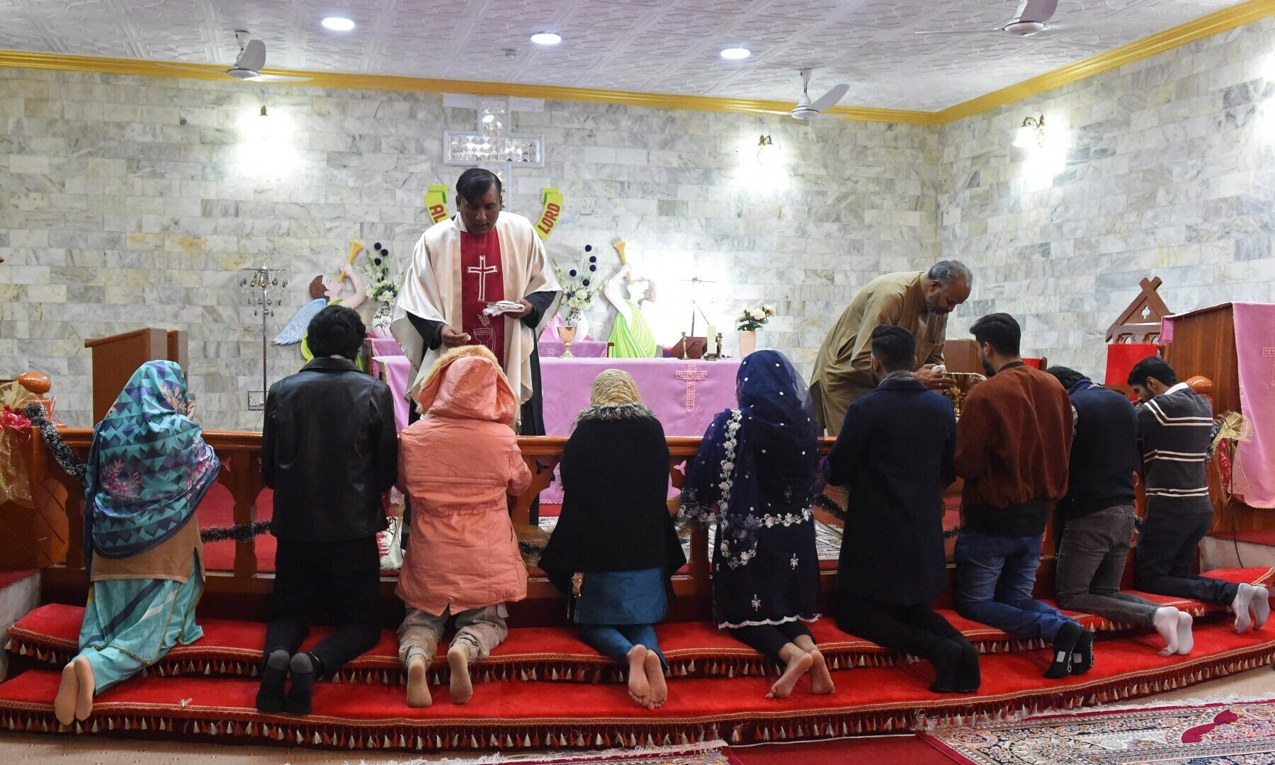 Christian devotees take part in a Christmas prayer at the Bethel Memorial Methodist Church in Quetta on December 25, 2022. — AFP