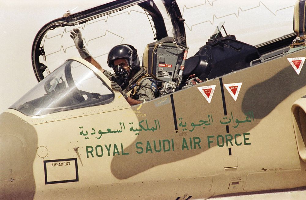 A pilot of the Royal Saudi Air Force waves at an Air Base in Saudi Arabia.
