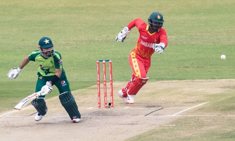 Mohammad Rizwan (L) runs between the wickets as Zimbabwe's wicketkeeper Regis Chakabva (R) fields during the first Twenty20 international between Zimbabwe and Pakistan at the Harare Sports Club in Harare on April 21. — AFP