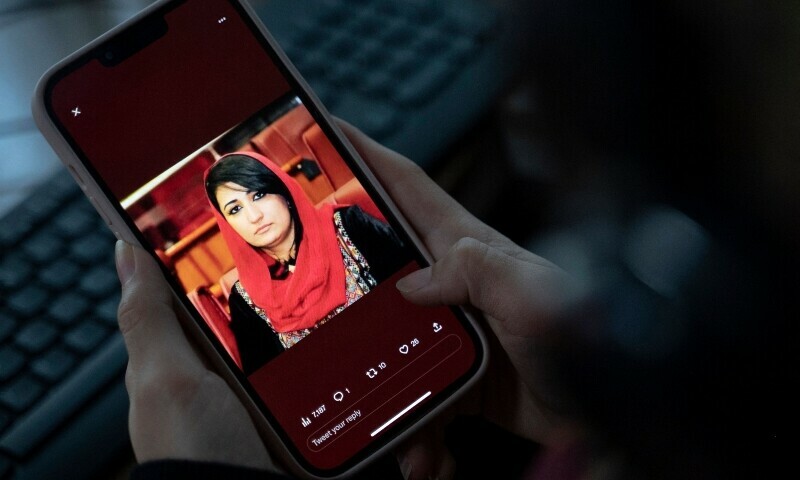 <p>A woman looks at a picture of former Afghan lawmaker Mursal Nabizada on her mobile phone, who was shot dead by gunmen last night at her house in Kabul, Afghanistan on January 15. — AFP</p>