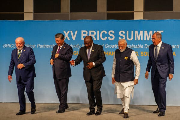 President Luiz Inacio Lula da Silva of Brazil, President Xi Jinping of China, President Cyril Ramaphosa of South Africa, Prime Minister Narendra Modi of India and Sergei Lavrov, the foreign minister of Russia, walk after posing for a picture.