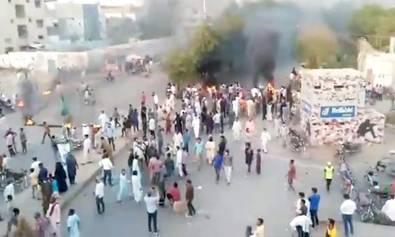 Smoke rises after objects were set on fire during a TLP protest in Karachi's Korangi area. — Photo: Twitter