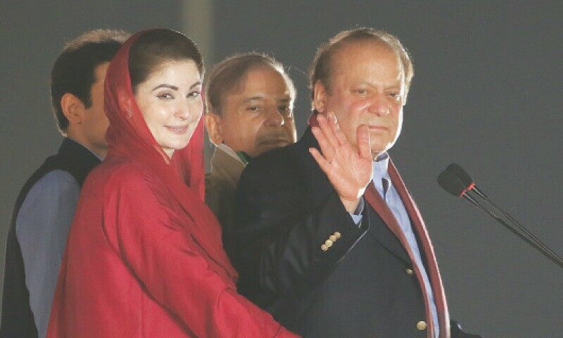 Nawaz Sharif waves to the crowd, alongside his daughter Maryam and brother Shehbaz, upon his arrival at the Minar-i-Pakistan rally on Saturday.—Murtaza Ali / White Star