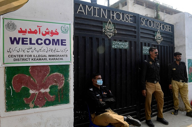 Police personnel stand guard outside a holding centre, newly opened to process and deport Afghans in Karachi on November 1, 2023. PHOTO: AFP