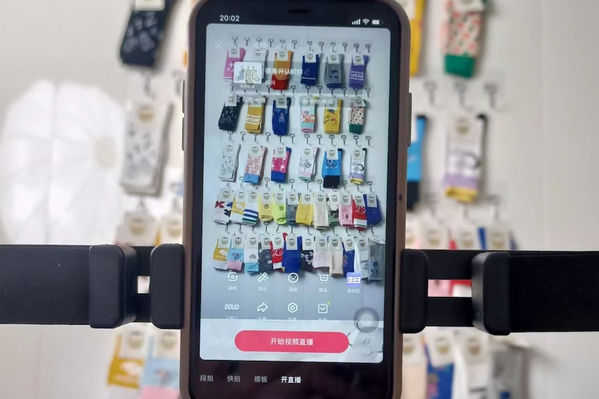 An iPhone with a lot of socks hanging off the back
