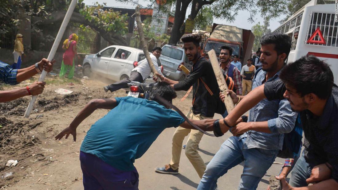 A protester is beaten by Indian students after members of the Dalit community and other low caste groups threw bricks at their college during countrywide protests on April 2, 2018 in Meerut in Uttar Pradesh state, India. The protesters opposed a Supreme Court order they felt diluted the rights of members of the lower castes. 