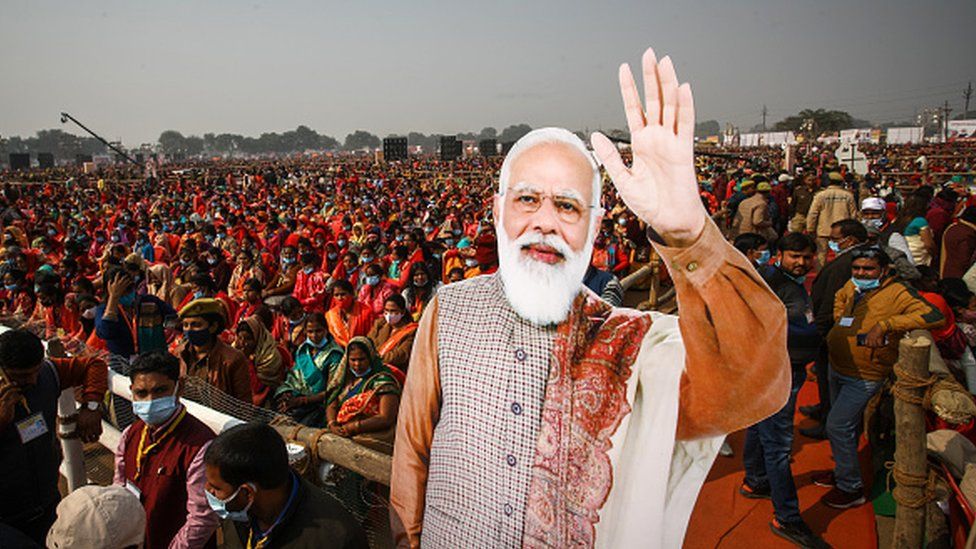 Women from various districts are seen near cut-outs of India's Prime Minister Narendra Modi at a rally held by Modi on December 21, 2021 in Allahabad, India.'s Prime Minister Narendra Modi at a rally held by Modi on December 21, 2021 in Allahabad, India.