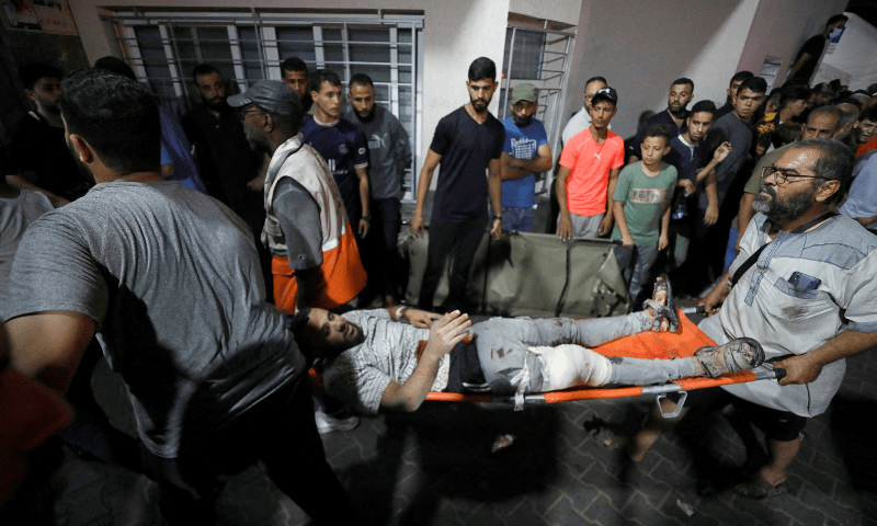  An injured person is assisted after an Israeli air strike hit At Al-Ahli Hospital, according to Gaza Health Ministry in Gaza City, Gaza Strip, October 17. — Reuters 