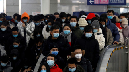 FILE PHOTO: People wearing face masks commute in a subway station during morning rush hour, following the coronavirus disease ( COVID-19) outbreak, in Beijing, China January 20, 2021. REUTERS/Tingshu Wang