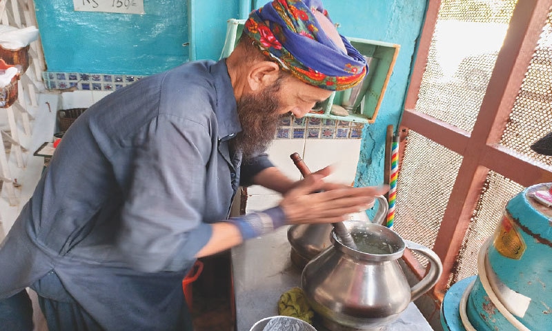 Rehmat Baba churning fresh lassi for a customer