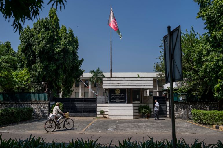 A cyclist pedals past the Afghan Embassy in New Delhi