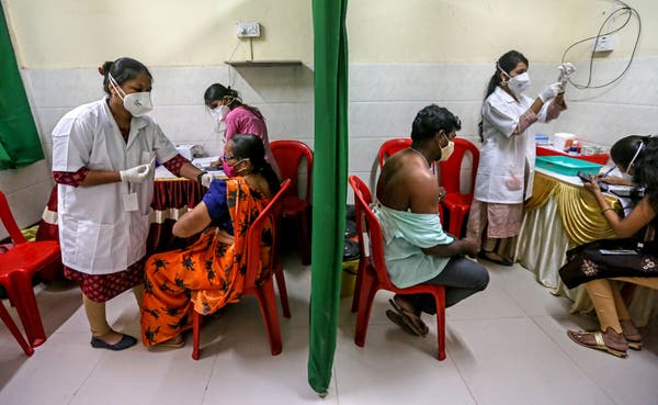 Residents of the Dharavi slum getting coronavirus vaccine in Mumbai, India.
