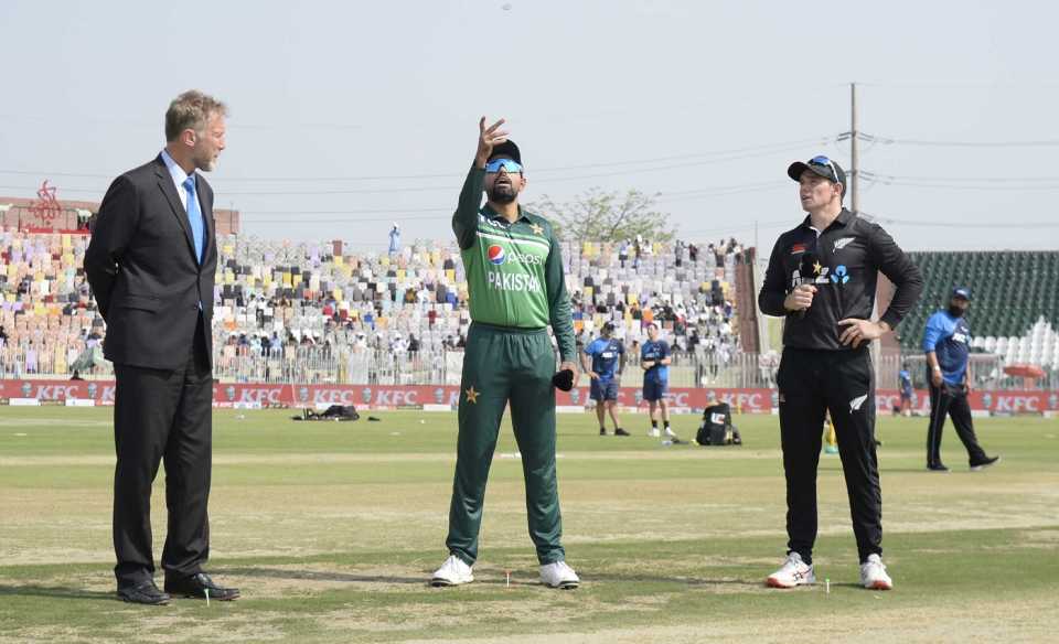 Babar Azam spins the coin as Tom Latham and Chris Broad look on