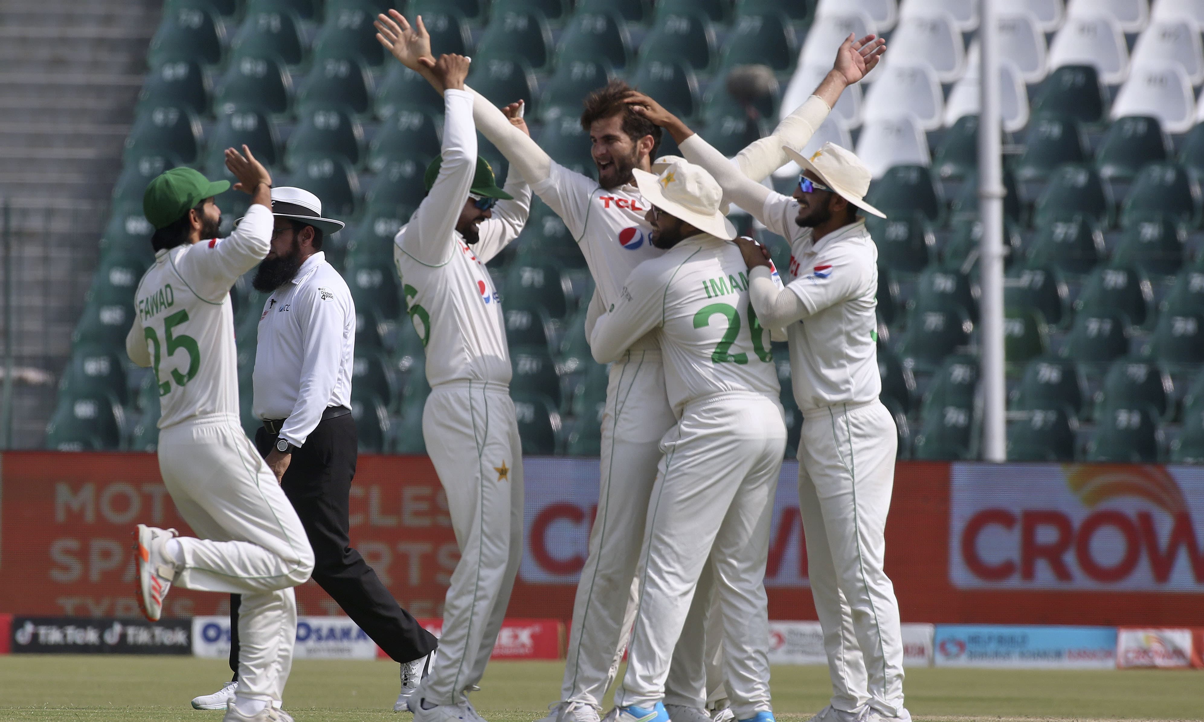 Pakistan's Shaheen Shah Afridi, centre, celebrates with teammates after the dismissal of Australia's Marnus Labuschagne on the first day of the third Test between Pakistan and Australia at the Gaddafi Stadium in Lahore on Monday. — AP