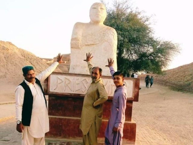 three visitors can be seen dishonouring king priest at a site of mohenjo daro photo express