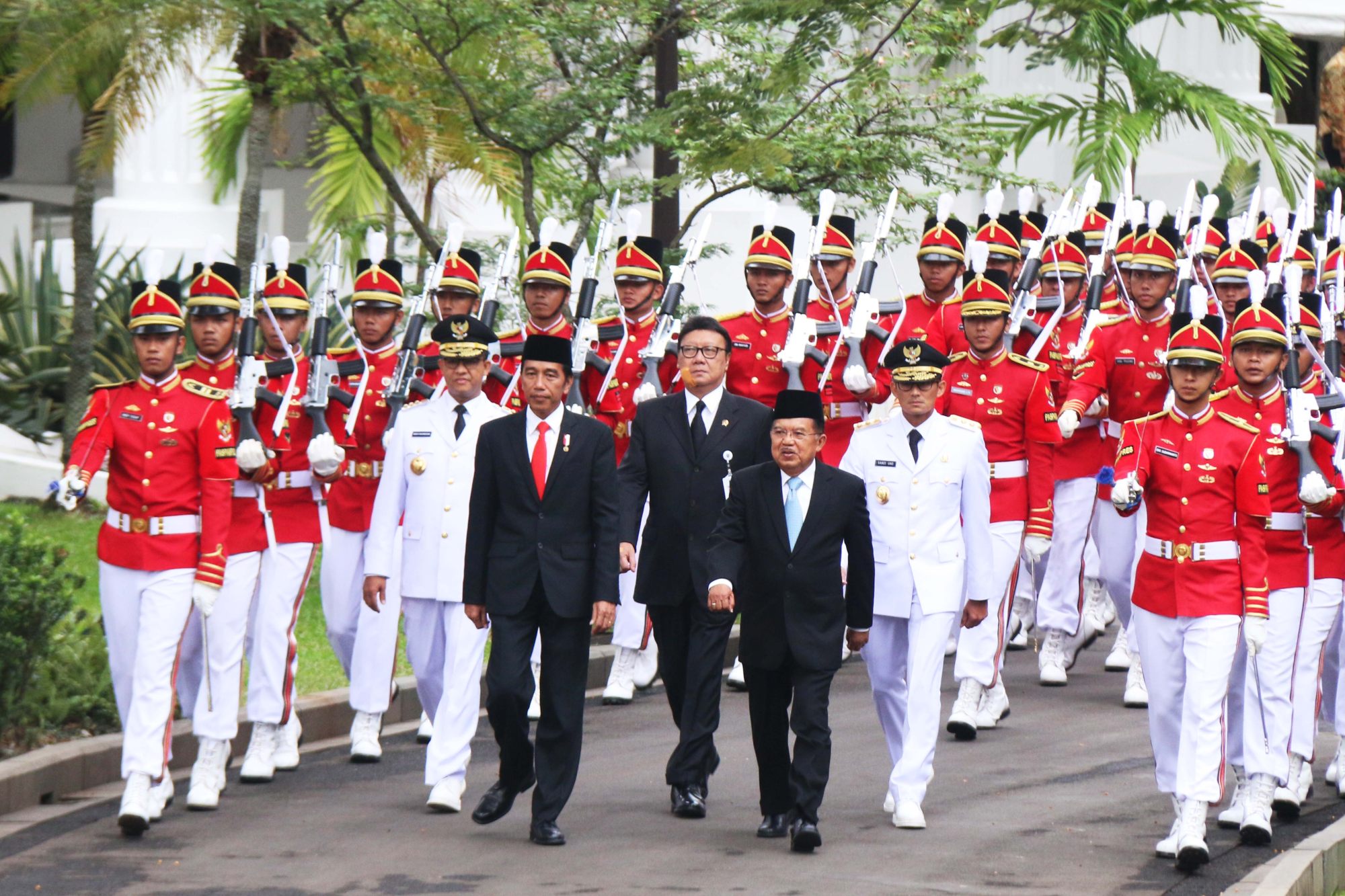Anies Baswedan (front L, in white), a former aide to Indonesian President Joko Widodo (centre L). File photo: AFP