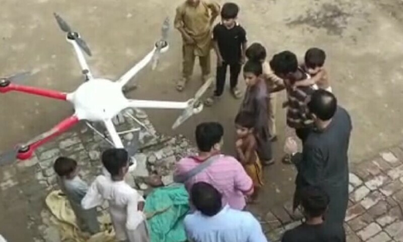 People gather in Lahore’s Kahna after a drug-laden drone crashed in the area on Friday. — Photo by author.