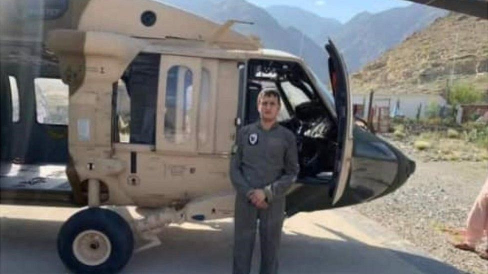 Momand standing in front of his Black Hawk helicopter