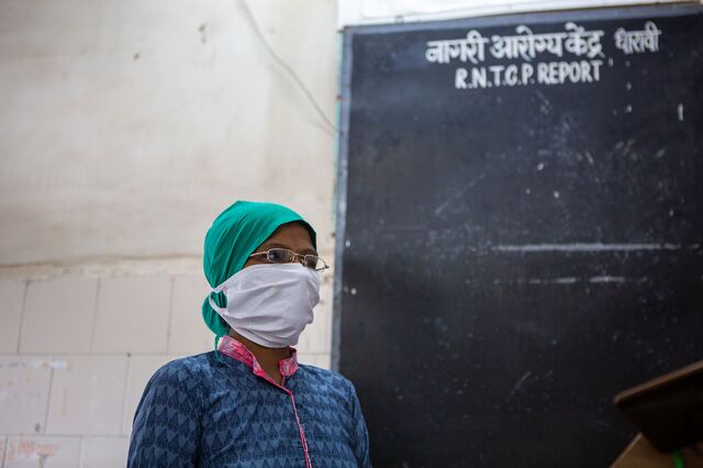 Sunanda Bhoyar, a community field worker gets ready at the Chota Sion hospital, to step into the field in Dharavi where she is tracing the chain of the virus and documenting, warning neighbors to stay safe inside their homes, and to maintain social distancing while a neighbor has been found Covid positive and to monitor the overall sanitation of the area. 16th July 2020.