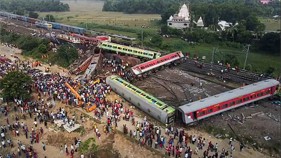 This screen grab made from AFPTV video footage taken on June 3, 2023 shows people gathering at the accident site of a three-train collision near Balasore, about 200 km (125 miles) from the state capital Bhubaneswar in the eastern state of Odisha.
