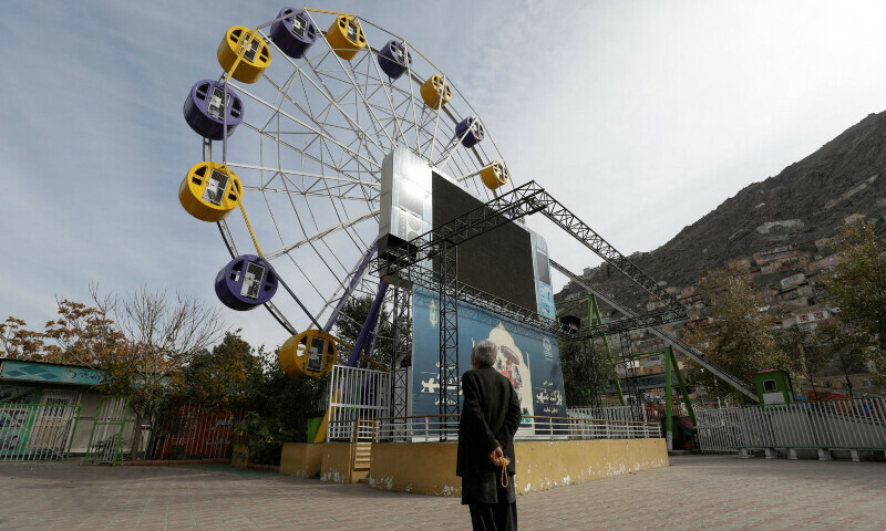 <p>An Afghan man stands in an amusement park in Kabul, Afghanistan, November 9. — Reuters</p>