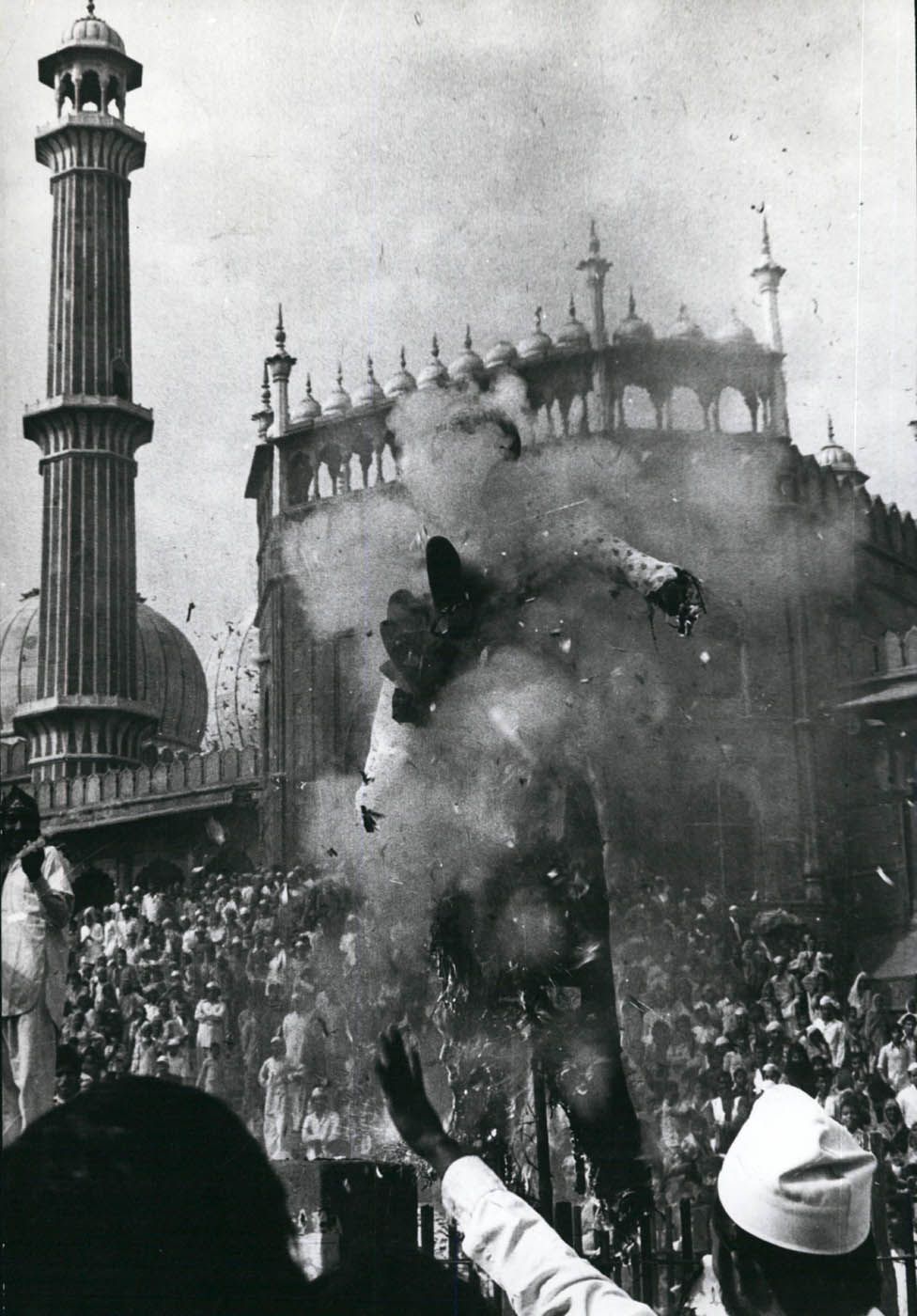 Demonstrators outside the Grand Mosque burn an effigy in protest against the building's seizure