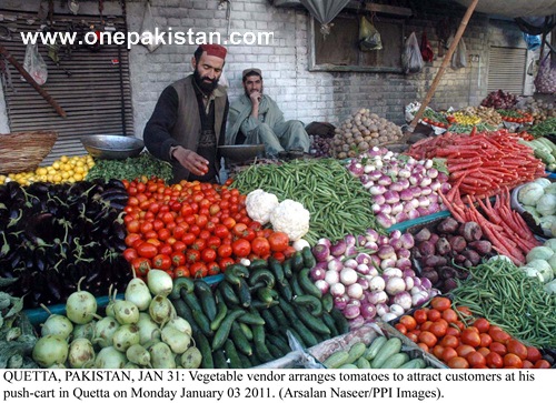 vegetable-vendor-arranges-tomatoes-to-attract-customers-at-his-push-cart-in-quetta.jpg