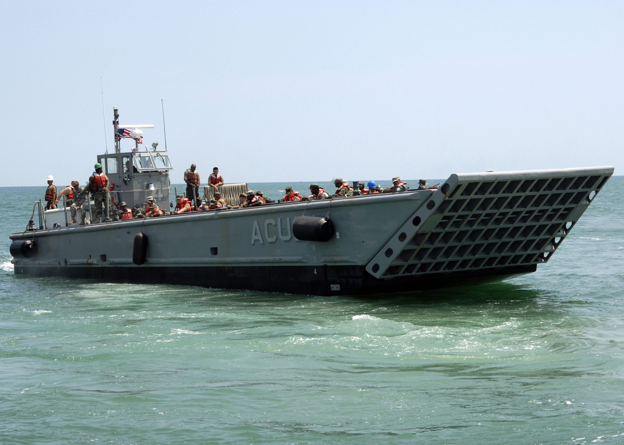 US_Navy_090615-N-6676S-456_Landing_Craft_Mechanized_(LCM)_14,_assigned_to_Assault_Craft_Unit_(ACU)_2,_transports_Sailors,_Soldiers_and_Marines_during_operations_supporting_Joint_Logistics_Over-The-Shore_(JLOTS)_exercises.jpg