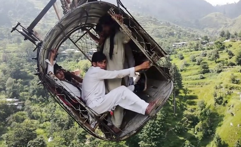  In this still from drone footage obtained by BBC News, the occupants of the chairlift are seen suspended hundreds of feet above the valley in Battagram’s Allai tehsil. 
