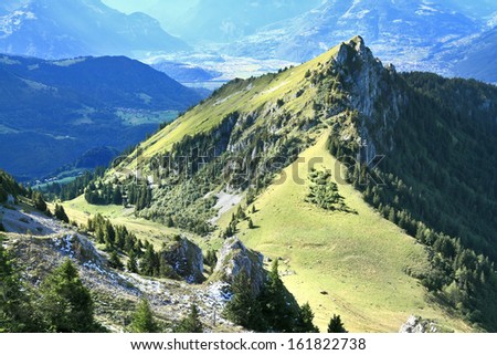 stock-photo-gorgeous-weather-in-the-swiss-alps-picturesque-jagged-peaks-and-gentle-alpine-meadows-away-misty-161822738.jpg