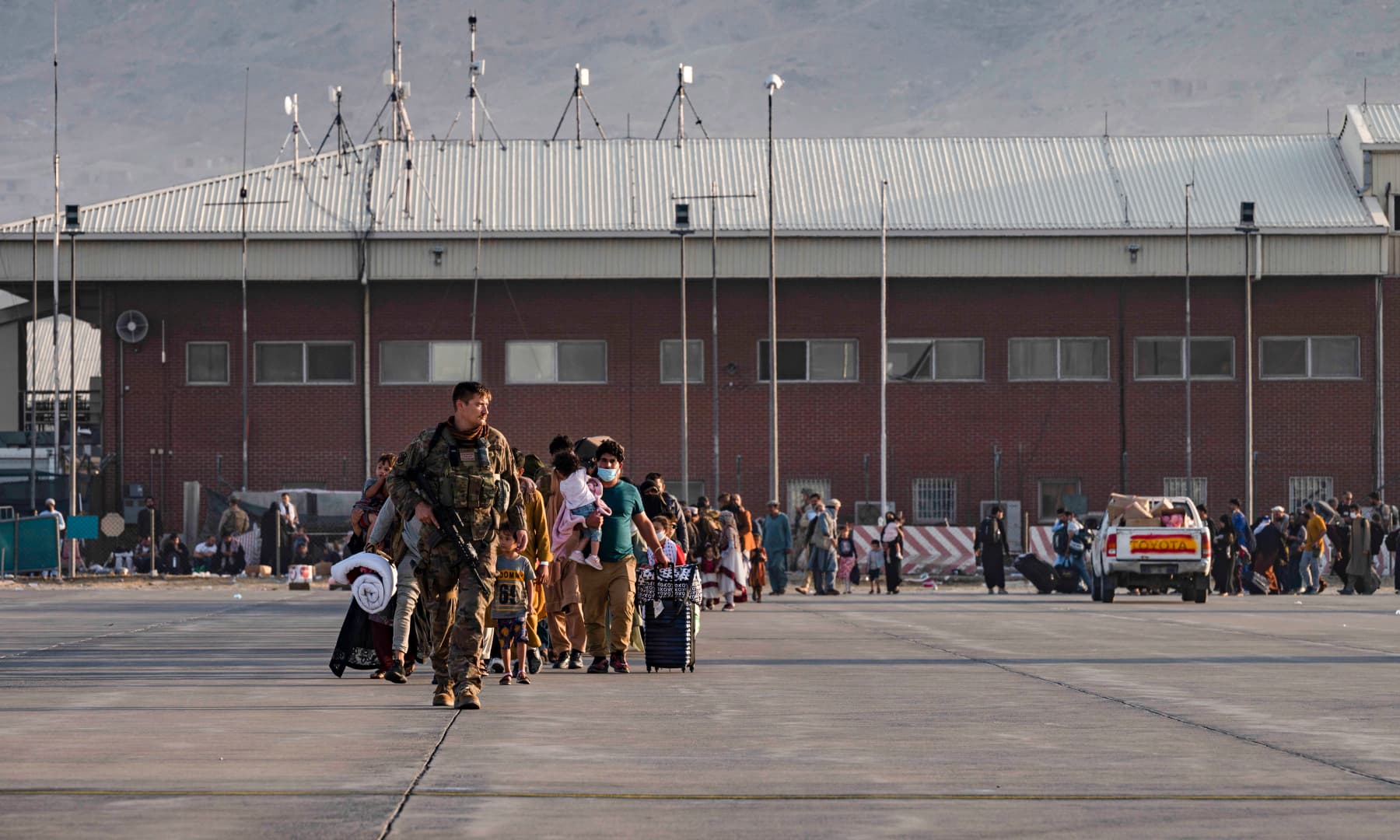 A US Air Force airman guides evacuees to board a US Air Force C-17 Globemaster III at Hamid Karzai International Airport in Kabul, Afghanistan on August 24, 2021. — AP