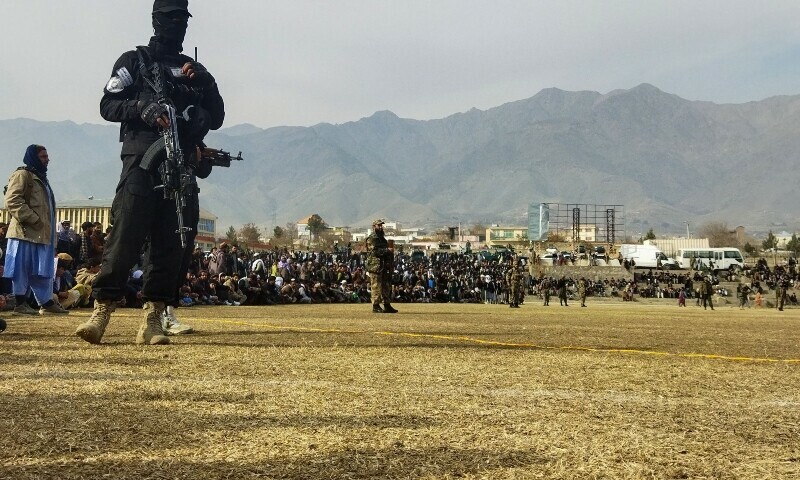 <p>A Taliban security personnel stands guard as people attend to watch publicly flogging of women and men at a football stadium in Charikar city of Parwan province on December 8, 2022. - The Taliban flogged 27 Afghans, including women, in front of a large crowd December 8, a day after publicly executing a convicted murderer for the first time since they returned to power last year. — AFP</p>