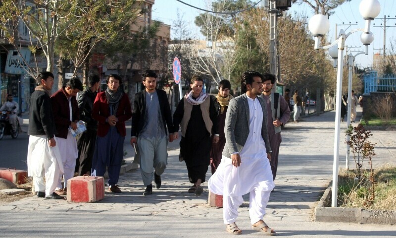 <p>Male students arrive at the Herat University after the universities were reopened in Herat on March 6, 2023. — AFP</p>