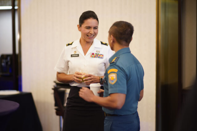 Maj. Tulsi Gabbard, Hawaii Army National Guard military police officer, reviews the operation design process with a Tentara Nasional Indonesia officer during a group break out, Jakarta, Indonesia, August 19, 2019. Hawaii National Guard is State Partners with Indonesia and regularly holds combined exercises and events to increase the depth of that relationship. This is the second year the Hawaii and Indonesia have participated in an operation design seminar. operation design is a process where a committee of military members and sometimes members of government examine very complex problems to help define variables, goals, tension points and desired end state to aid in the planing and execution of military or governmental action. (U.S. Air National Guard Photo by Tech. Sgt. Andrew Jackson)