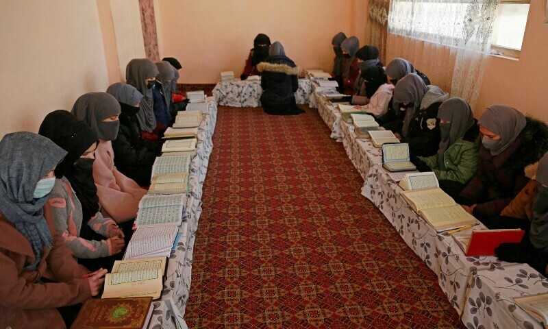 In this picture taken on February 13, 2023, Afghan girls learn the holy Quran at a madrassa or an Islamic school on the outskirts of Kabul. — AFP