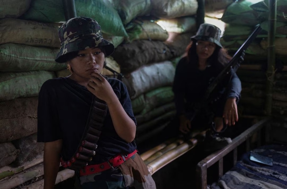 Hatey Haokip (L), 22, and Themboi Waibhai, 20, Kuki armed women, sit inside a bunker at a frontline village in Churachandpur district in the northeastern state of Manipur, India. (Reuters)
