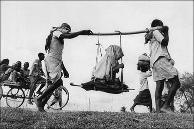 Two-men-carrying-woman1947.jpg