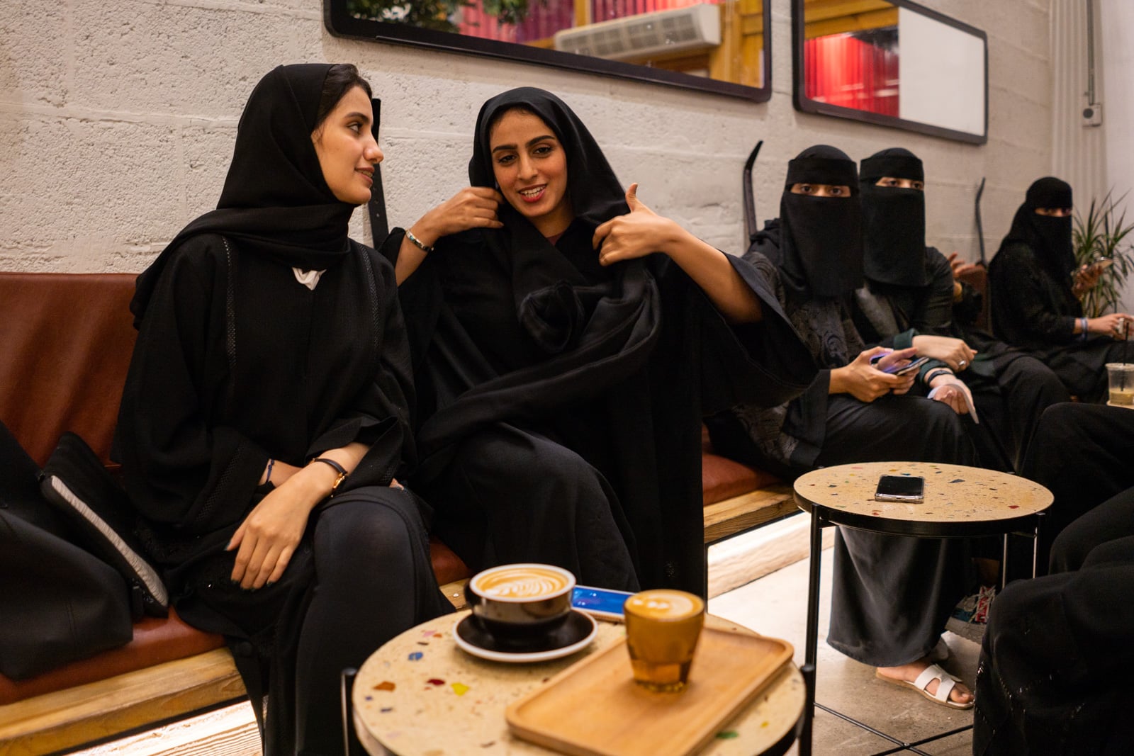 Young women in black sitting in the family section of a cafe in Jazan, Saudi Arabia