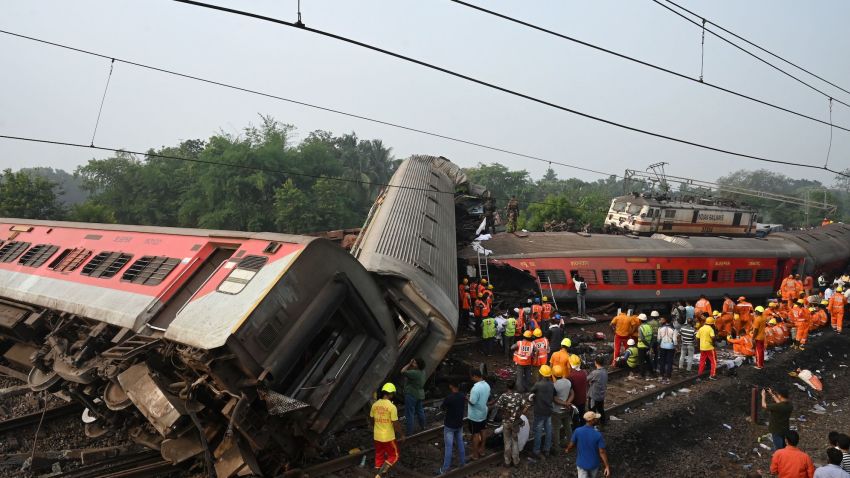Rescue workers gather around damaged carriages during search for survivors at the accident site of a three-train collision near Balasore, about 200 km (125 miles) from the state capital Bhubaneswar in the eastern state of Odisha, on June 3, 2023. At least 288 people were killed and more than 850 injured in a horrific three-train collision in India, officials said on June 3, the country's deadliest rail accident in more than 20 years. (Photo by DIBYANGSHU SARKAR / AFP) (Photo by DIBYANGSHU SARKAR/AFP via Getty Images)