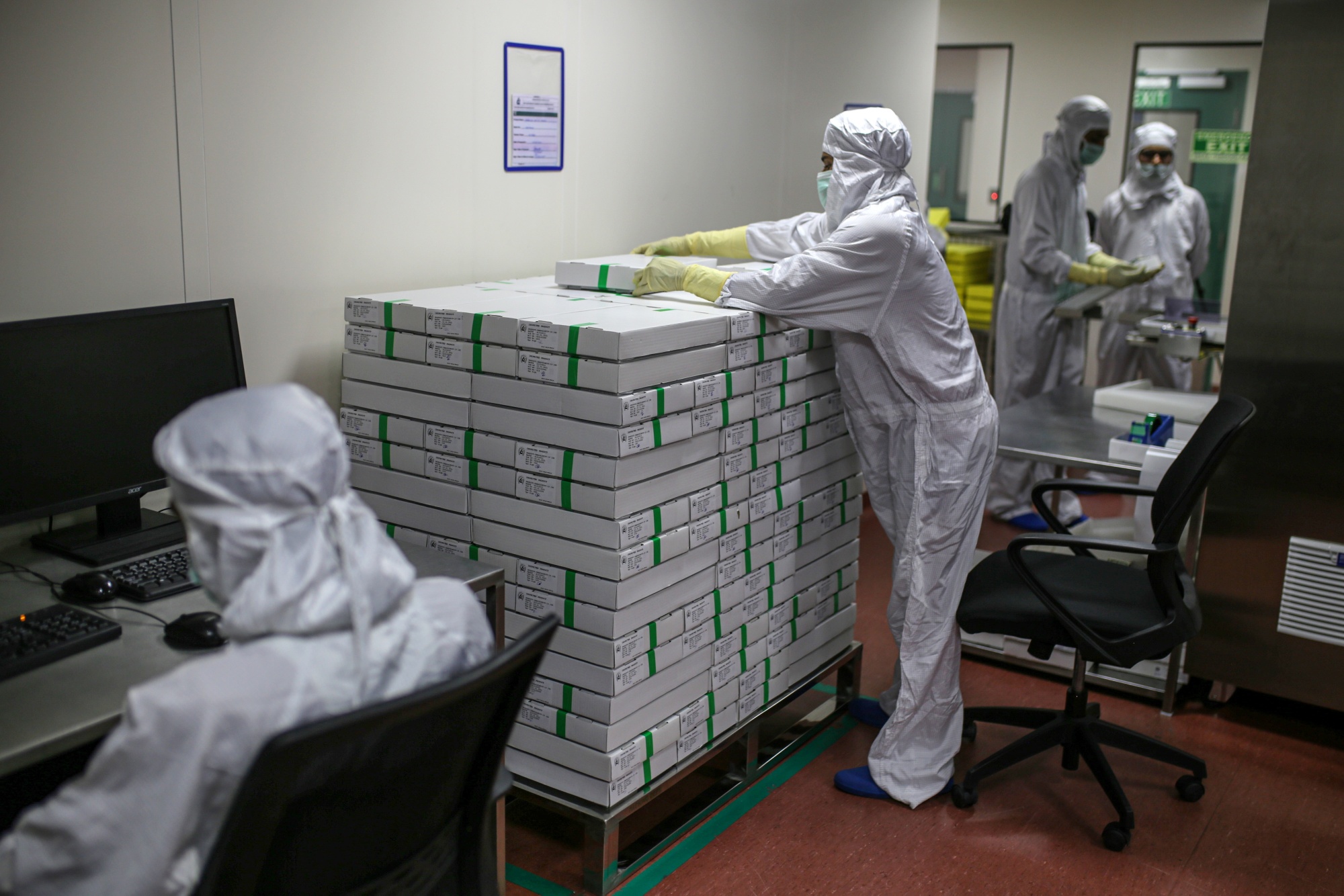 A employee stacks packed vials of Covishield, the local name for the vaccine developed by AstraZeneca, at the Serum plant in Maharashtra, on Jan. 22.