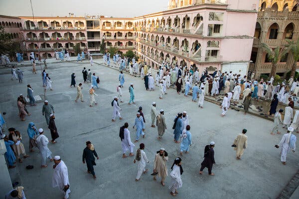 Students walking in front of their dormitories after prayers on campus.