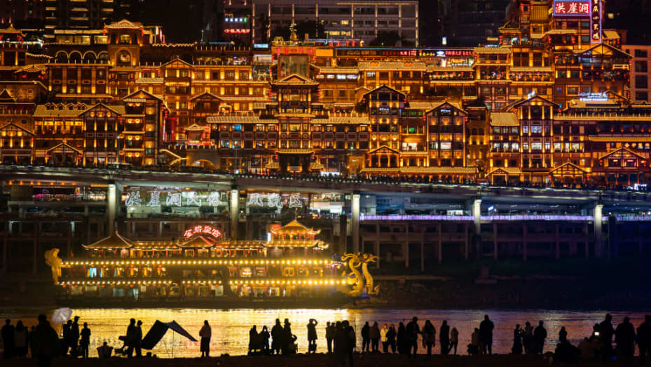 Tourists enjoy the night view along the Jialing River on February 15, 2023 in Chongqing, China.