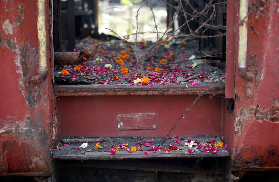 flower petals scattered by the relatives of godhra riots victims are pictured at the doorsteps of a train carriage that was set on fire in 2002 during the commemoration of the 12th anniversary of godhra riots at godhra in the western indian state of gujarat february 27 2014 photo reuters file
