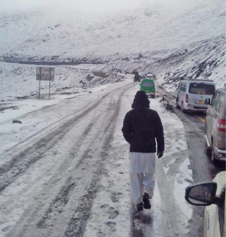 Traffic resumes on MNJ Road on Monday after clearance of snow. — Dawn