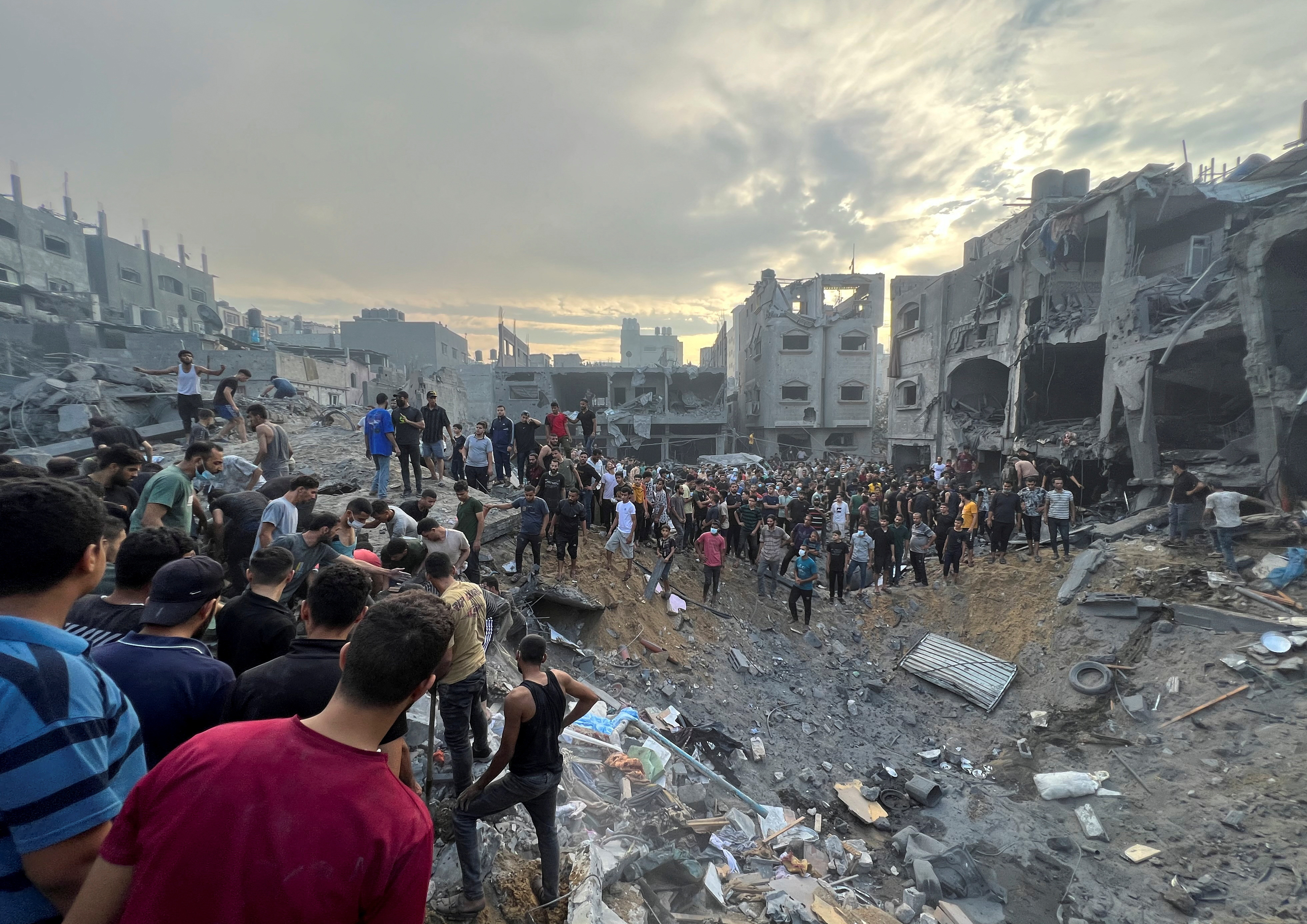 Palestinians search for casualties at the site of Israeli strikes on houses in Jabalia refugee camp