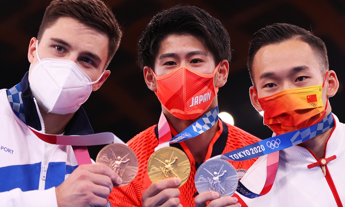 Bronze medalist Nikita Nagornyy of Team ROC, gold medalist Daiki Hashimoto of Team Japan and silver medalist Ruoteng Xiao of Team China pose with their medals during the Men's All-Around Final on day five of the Tokyo 2020 Olympic Games at Ariake Gymnastics Centre on July 28, 2021 in Tokyo, Japan. 