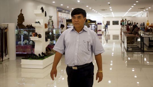businessman-nguyen-huu-duong-walks-inside-a-store-in-his-building-in-hanoi-vietnam-june-29-2015-reuterskham.jpg