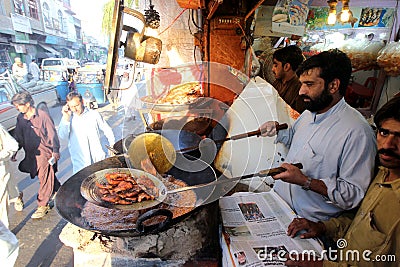 fish-seller-busy-frying-fish-mingora-main-town-pakistan-s-swat-valley-29874466.jpg