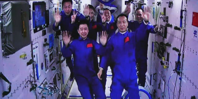 This image captured at the Jiuquan Satellite Launch Center in northwest China shows the Shenzhou-15 and Shenzhou-14 crew waving after a historic gathering in space on Nov. 30, 2022. The three astronauts aboard China's Shenzhou-15 spaceship entered the country's space station and met with another astronaut trio on Wednesday, a historic gathering that added the manpower at the in-orbit space lab to six for the first time.